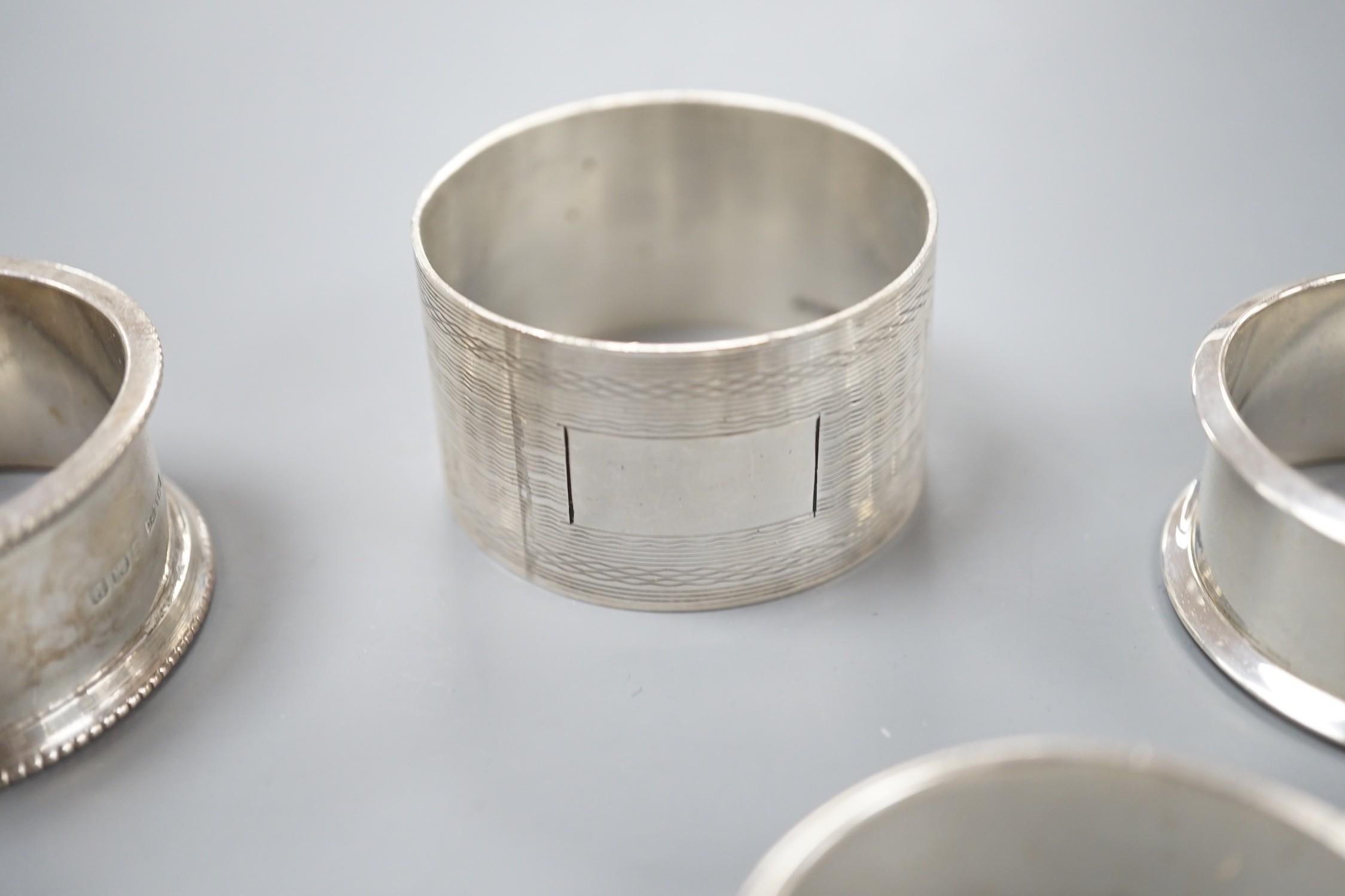 Seven assorted 20th century silver napkin rings, 121 grams.